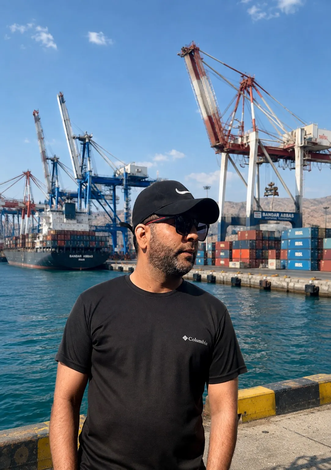 Hamed Khodabakhshi at Bandar Abbas export port with cargo cranes and vessel operations