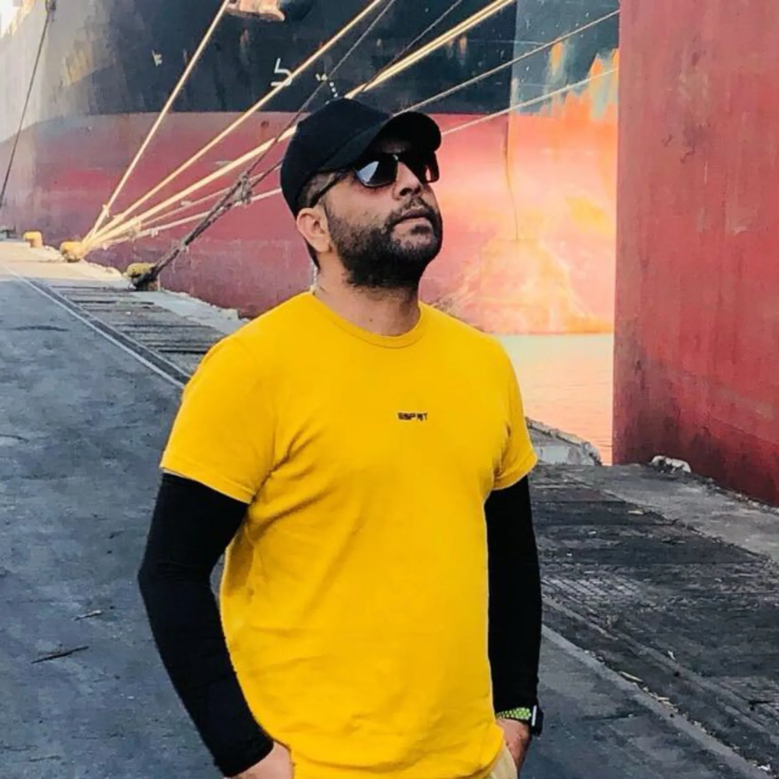 Hamed Khodabakhshi beside a cargo vessel during port-side export operations